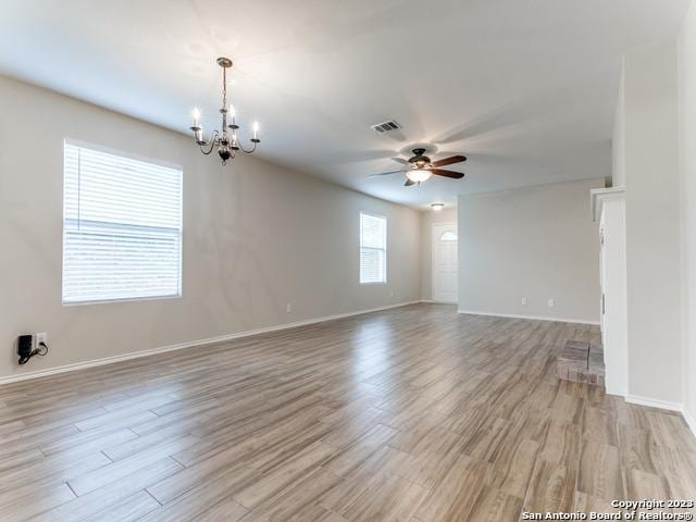 1818 Vinca Mnr, San Antonio, TX 78260 - unfurnished room with a chandelier, a ceiling fan, light wood-style flooring, and baseboards