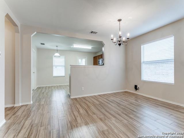 1818 Vinca Mnr, San Antonio, TX 78260 - unfurnished room featuring a chandelier, light wood-style flooring, and baseboards