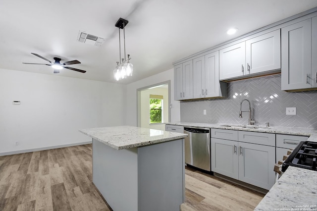 5515 Rolling Rdg, San Antonio, TX 78228 - kitchen with stainless steel dishwasher, a sink, tasteful backsplash, a center island, and gray cabinets