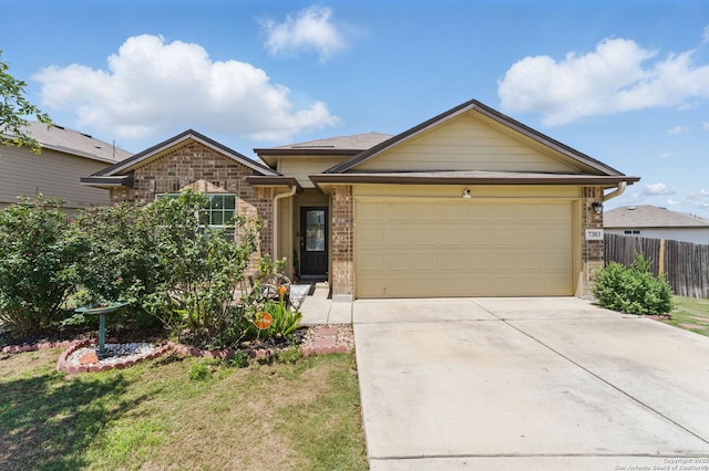 7303 Altair Loop, San Antonio, TX 78252 - view of front of house featuring a garage, brick siding, and driveway
