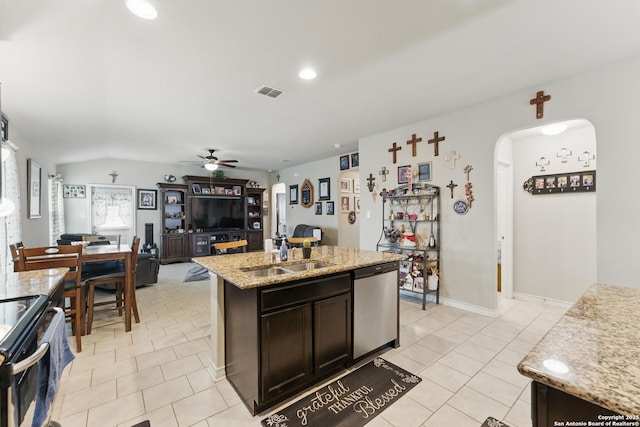 7303 Altair Loop, San Antonio, TX 78252 - kitchen with a sink, stainless steel appliances, ceiling fan, arched walkways, and dark brown cabinets