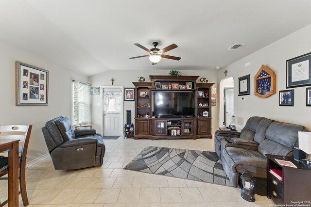 7303 Altair Loop, San Antonio, TX 78252 - living area with a ceiling fan, arched walkways, vaulted ceiling, and light tile patterned flooring