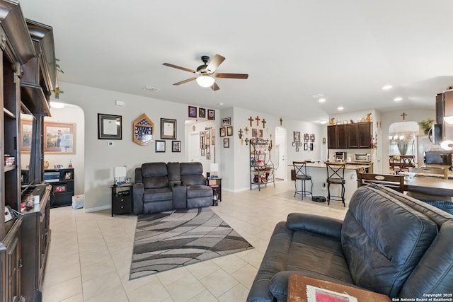 7303 Altair Loop, San Antonio, TX 78252 - living room with a ceiling fan, light tile patterned flooring, arched walkways, recessed lighting, and baseboards