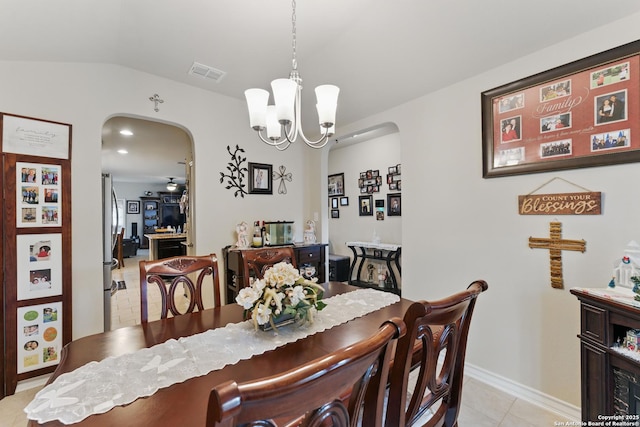 7303 Altair Loop, San Antonio, TX 78252 - dining area featuring arched walkways, a chandelier, light tile patterned floors, baseboards, and vaulted ceiling