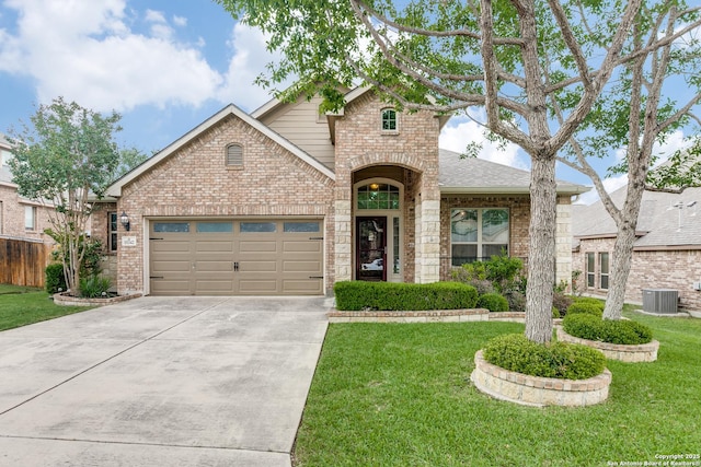 15342 Fort Marcy, San Antonio, TX 78245 - view of front facade with brick siding, driveway, central AC unit, a garage, and a front lawn