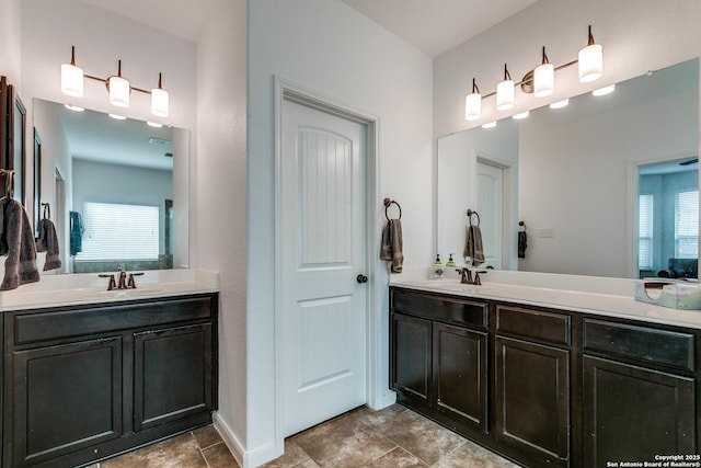 15342 Fort Marcy, San Antonio, TX 78245 - bathroom featuring two vanities and baseboards