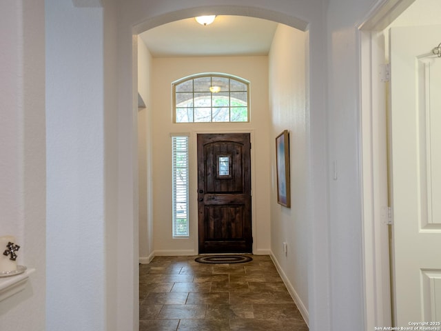 15342 Fort Marcy, San Antonio, TX 78245 - entrance foyer featuring baseboards, arched walkways, and dark stone finish flooring