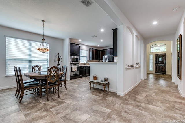 15342 Fort Marcy, San Antonio, TX 78245 - dining area with light stone finish floors, a chandelier, baseboards, and recessed lighting