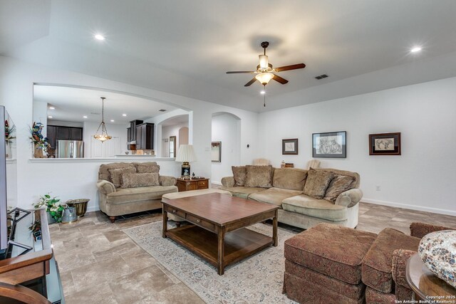 15342 Fort Marcy, San Antonio, TX 78245 - living area with a ceiling fan, arched walkways, light stone finish flooring, recessed lighting, and baseboards