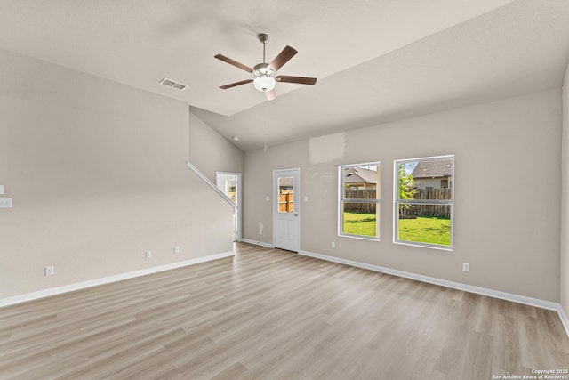 8205 Foxtail Frk, San Antonio, TX 78222 - unfurnished living room with ceiling fan, light wood-type flooring, baseboards, and vaulted ceiling
