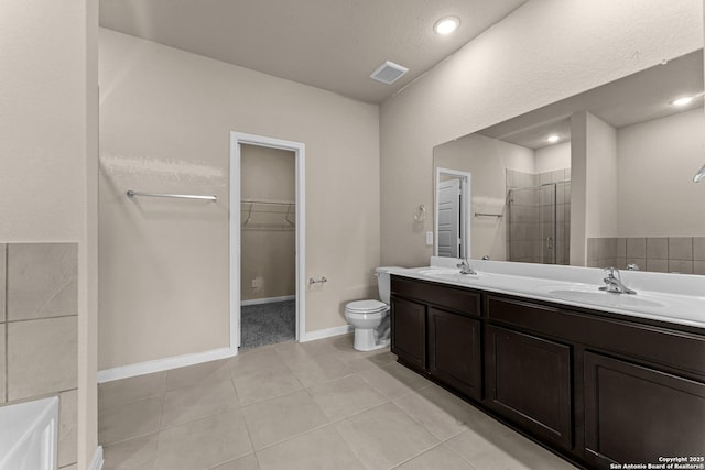 8205 Foxtail Frk, San Antonio, TX 78222 - bathroom featuring a shower stall, double vanity, a spacious closet, toilet, and tile patterned floors