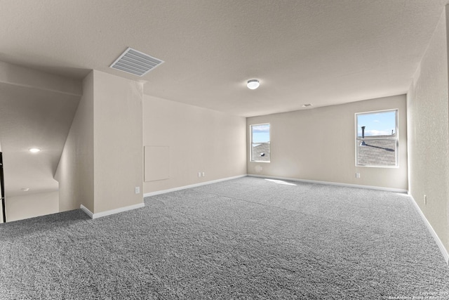 8205 Foxtail Frk, San Antonio, TX 78222 - carpeted empty room featuring baseboards and a textured ceiling