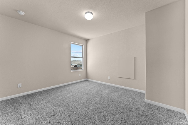 8205 Foxtail Frk, San Antonio, TX 78222 - carpeted empty room with baseboards, a textured ceiling, and a smoke detector