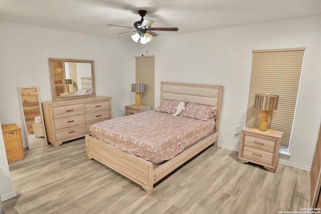 bedroom featuring light wood-style flooring and a ceiling fan