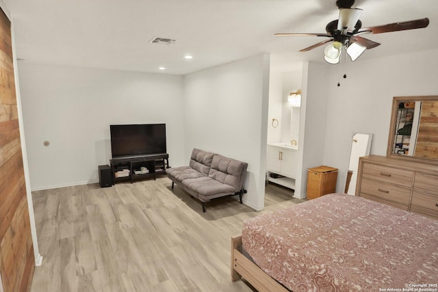 bedroom with wood finished floors, recessed lighting, a ceiling fan, baseboards, and connected bathroom
