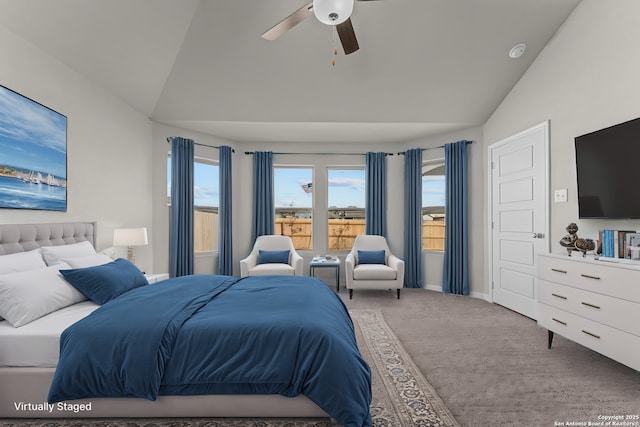carpeted bedroom featuring vaulted ceiling, baseboards, and a ceiling fan