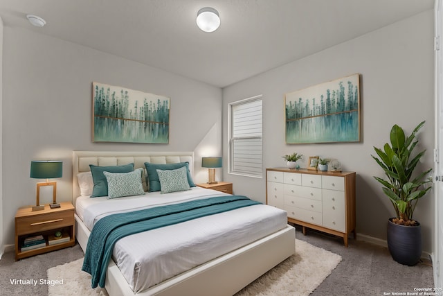 bedroom with carpet floors and baseboards