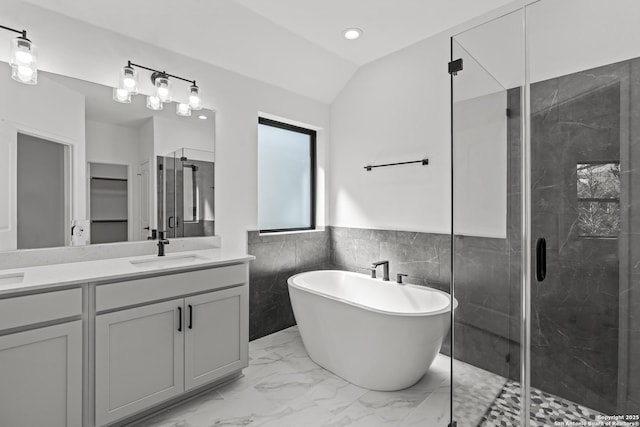 2171 Oak Run Pkwy, New Braunfels, TX 78132 - bathroom featuring a shower stall, tile walls, marble finish flooring, double vanity, and a freestanding tub