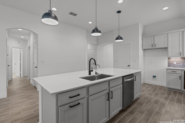 2171 Oak Run Pkwy, New Braunfels, TX 78132 - kitchen featuring arched walkways, stainless steel dishwasher, a sink, light wood-style flooring, and recessed lighting