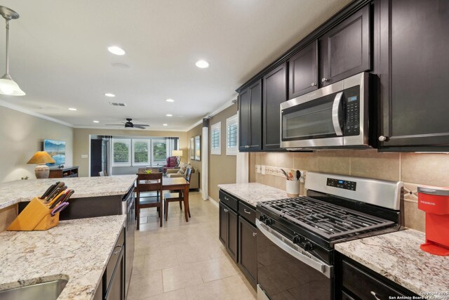 3819 Singing Water, San Antonio, TX 78253 - kitchen with stainless steel appliances, crown molding, recessed lighting, light stone counters, and a ceiling fan