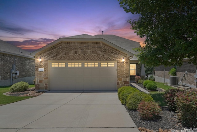 3819 Singing Water, San Antonio, TX 78253 - view of front of house with an attached garage, concrete driveway, stone siding, and a shingled roof