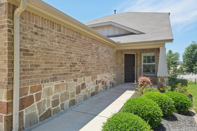 3819 Singing Water, San Antonio, TX 78253 - doorway to property with brick siding, board and batten siding, and roof with shingles
