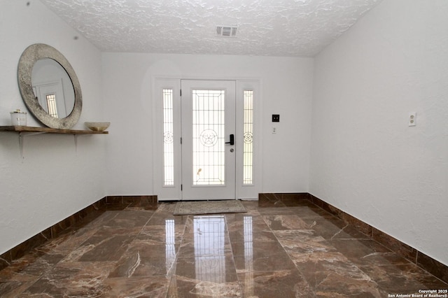 23127 Opportunity, Elmendorf, TX 78112 - entrance foyer featuring a textured ceiling, marble tiled floors, and baseboards