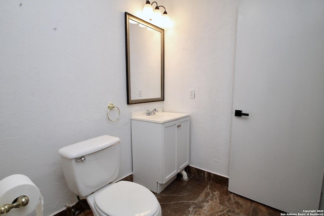 23127 Opportunity, Elmendorf, TX 78112 - bathroom featuring toilet, vanity, and baseboards