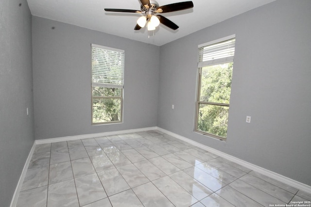 23127 Opportunity, Elmendorf, TX 78112 - unfurnished room with ceiling fan, light marble finish flooring, and baseboards