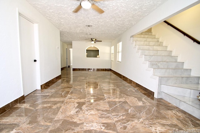 23127 Opportunity, Elmendorf, TX 78112 - corridor with a textured ceiling, stairs, marble tiled flooring, and baseboards