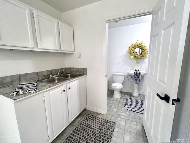 23127 Opportunity, Elmendorf, TX 78112 - bathroom featuring toilet, vanity, and baseboards