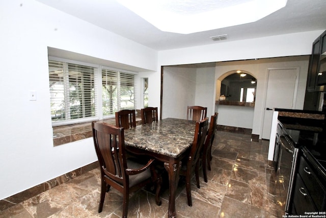 23127 Opportunity, Elmendorf, TX 78112 - dining area with baseboards, arched walkways, and healthy amount of natural light