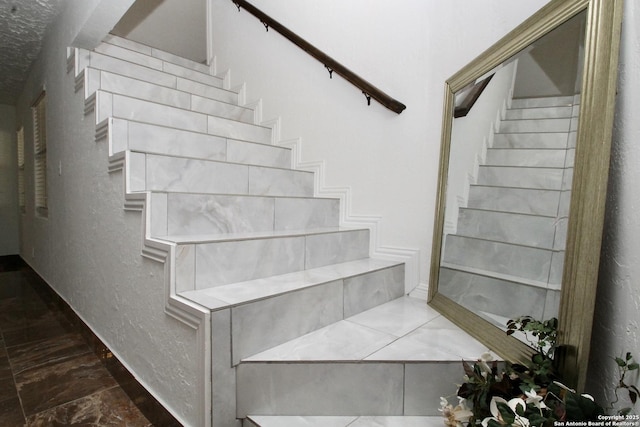 23127 Opportunity, Elmendorf, TX 78112 - staircase with marble finish flooring and a textured wall