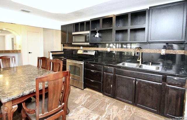 23127 Opportunity, Elmendorf, TX 78112 - kitchen with stainless steel appliances, a sink, tasteful backsplash, open shelves, and dark brown cabinetry