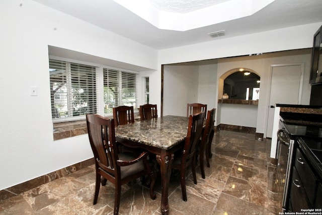 23127 Opportunity, Elmendorf, TX 78112 - dining space featuring arched walkways, baseboards, and a tray ceiling
