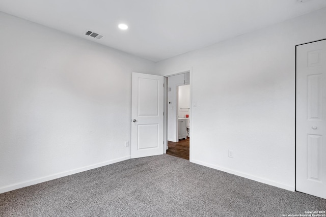 3018 Chihuahua, San Antonio, TX 78207 - unfurnished bedroom with dark colored carpet, baseboards, and recessed lighting
