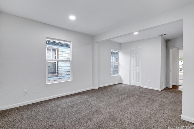 3018 Chihuahua, San Antonio, TX 78207 - empty room featuring healthy amount of natural light, dark carpet, baseboards, and recessed lighting