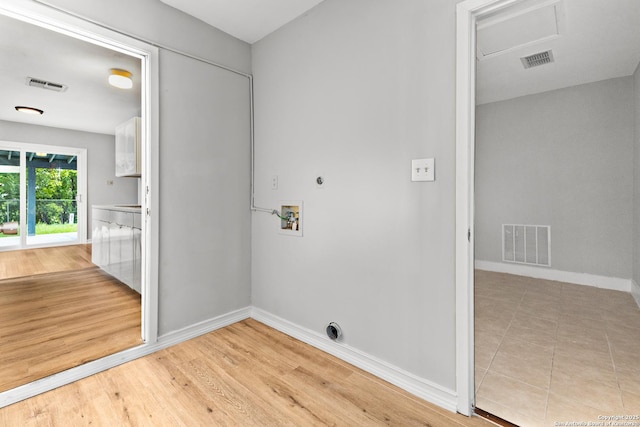 laundry area featuring hookup for an electric dryer, washer hookup, baseboards, and wood finished floors