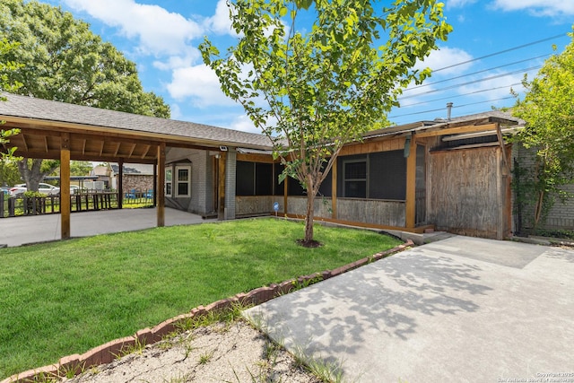 ranch-style house with a patio and a front yard