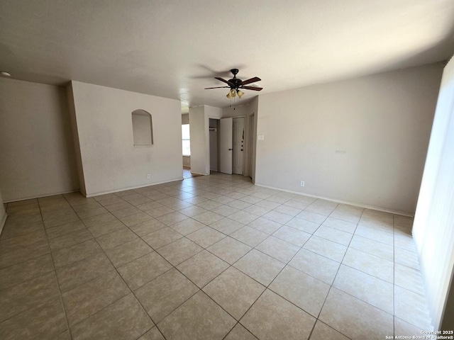 3123 Opal, San Antonio, TX 78245 - empty room featuring light tile patterned floors, ceiling fan, and baseboards