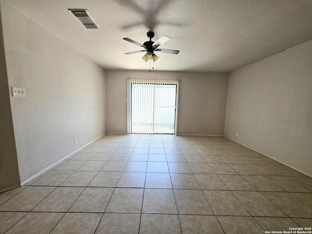 3123 Opal, San Antonio, TX 78245 - unfurnished room featuring a ceiling fan, light tile patterned flooring, a textured ceiling, baseboards, and a textured wall