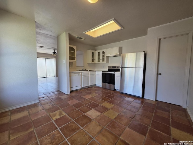 3123 Opal, San Antonio, TX 78245 - kitchen with stainless steel appliances, light countertops, white cabinetry, glass insert cabinets, and under cabinet range hood