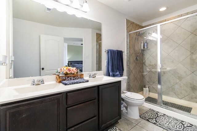 4351 E Safe Hbr, San Antonio, TX 78244 - bathroom featuring tile patterned floors, toilet, a stall shower, double vanity, and recessed lighting