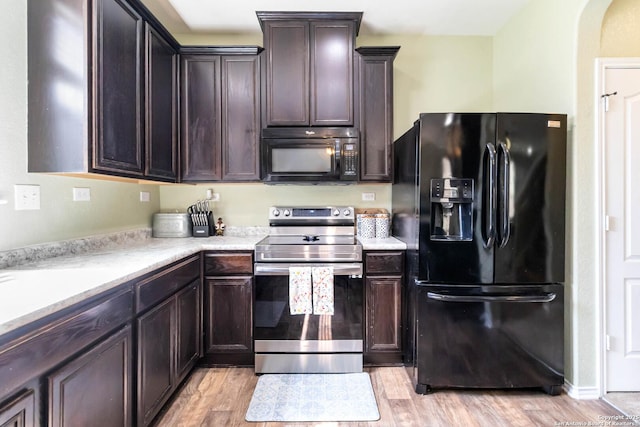4351 E Safe Hbr, San Antonio, TX 78244 - kitchen featuring black appliances, light wood-style floors, light countertops, dark brown cabinetry, and arched walkways