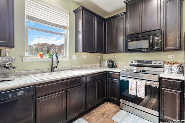 4351 E Safe Hbr, San Antonio, TX 78244 - kitchen with black appliances, a sink, light wood-type flooring, and light countertops