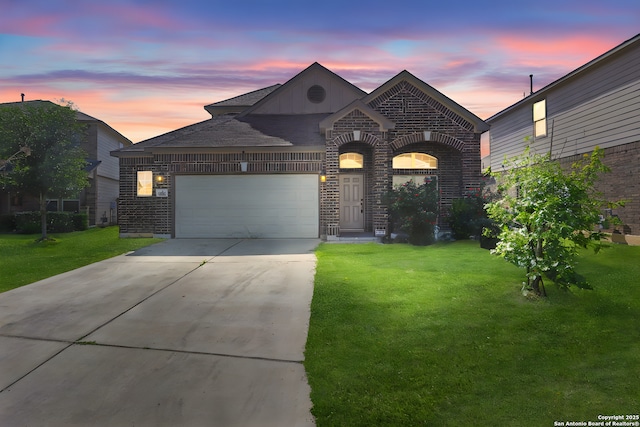 8228 Llano Parke, San Antonio, TX 78254 - french country style house featuring brick siding, a yard, a garage, and driveway