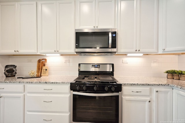 565 Rosemellow, New Braunfels, TX 78132 - kitchen with appliances with stainless steel finishes, white cabinets, and backsplash