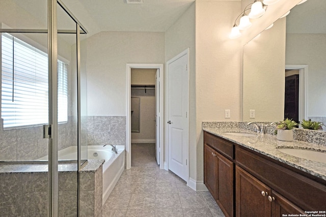 565 Rosemellow, New Braunfels, TX 78132 - bathroom featuring a bath, a stall shower, double vanity, and a walk in closet