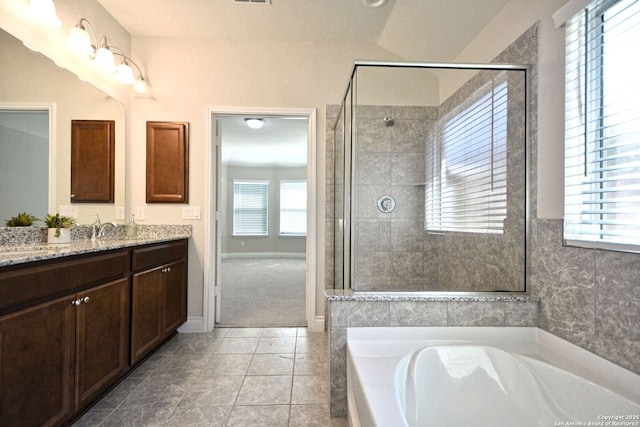 565 Rosemellow, New Braunfels, TX 78132 - full bathroom with vanity, a garden tub, a shower stall, and tile patterned floors