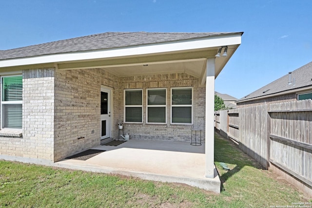 565 Rosemellow, New Braunfels, TX 78132 - back of property featuring a patio, fence, brick siding, and roof with shingles